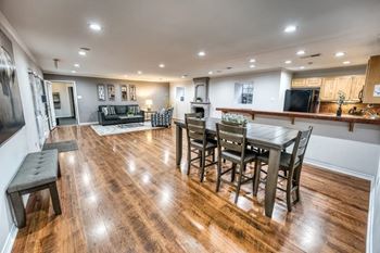 Open floor plan with dining table and hardwood floors